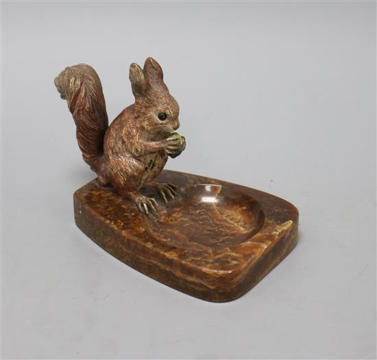 A cold-painted bronze model of a squirrel mounted on a brown onyx ashtray, H 10.5cm inc ashtray